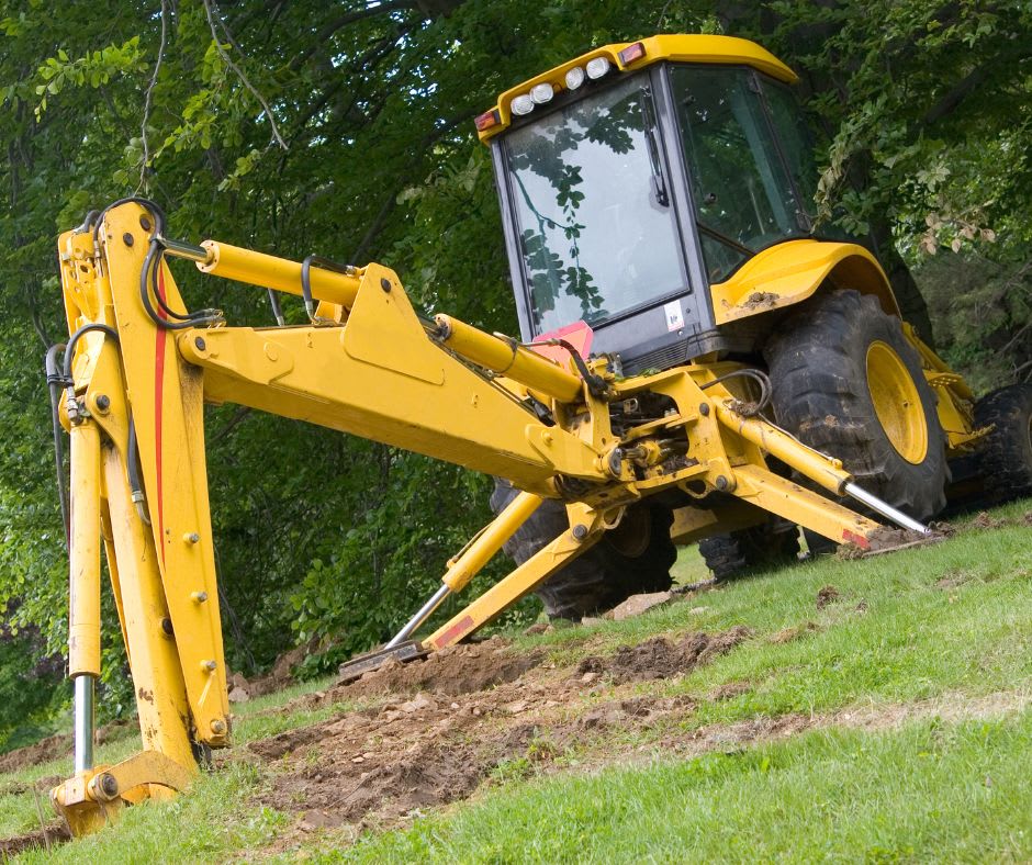 Backhoe loader using its stabilizer legs