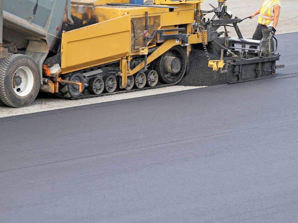 Asphalt paver laying the asphalt concrete