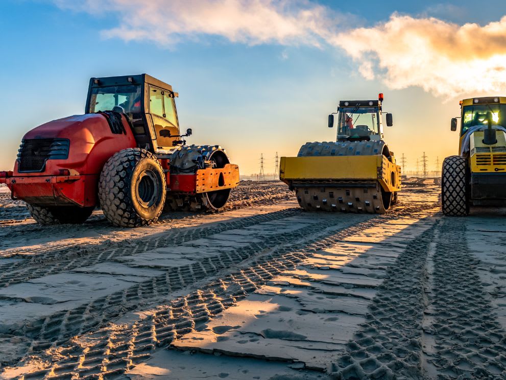 Three padfoot soil compactors being used to compact the ground