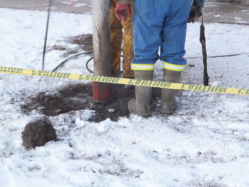 Vacuum excavator being used in winter to break through ground