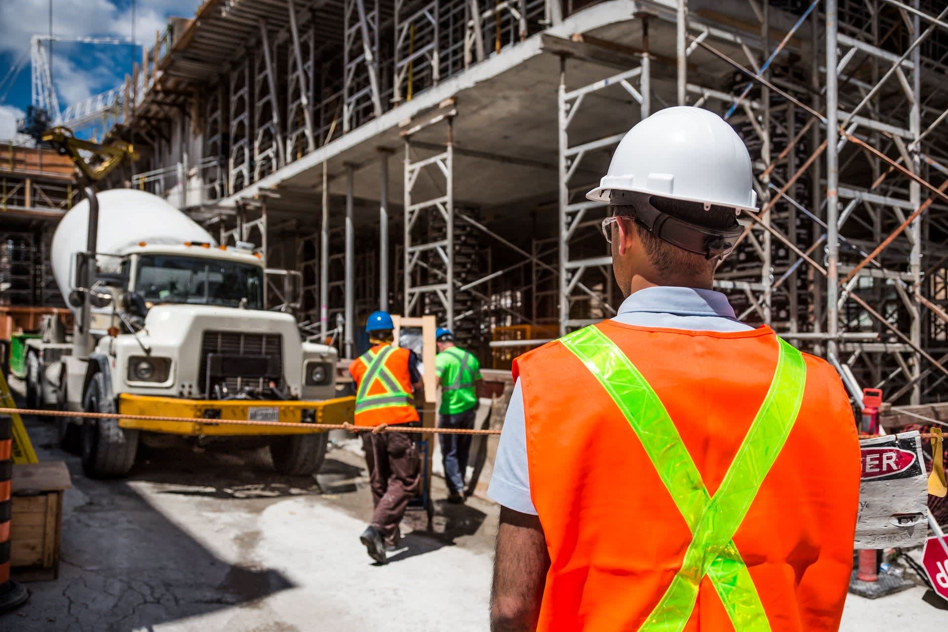 Construction site, in front of man, cement truck