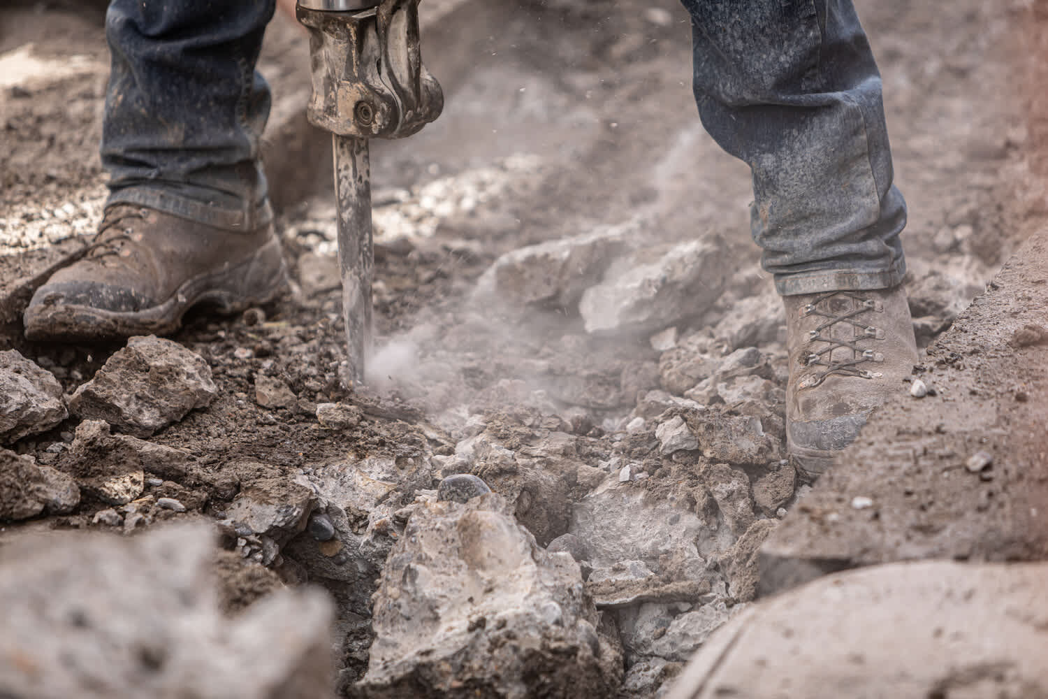 Man using jackhammer, shoes shot