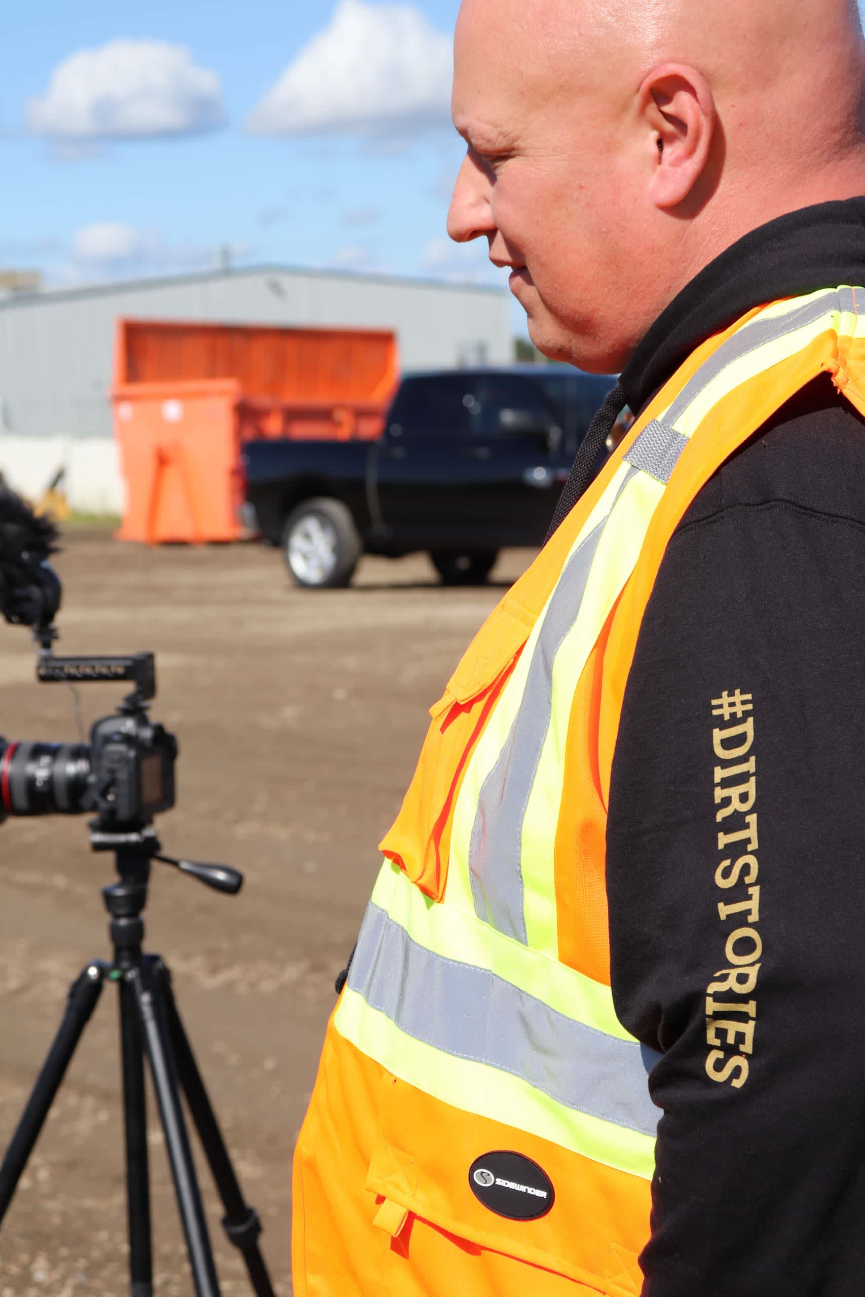 DOZR CEO Kevin Forestell on a site in a DirtStories sweater and PPE Vest