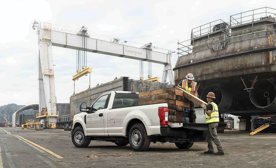 construction workers unloading materials from a pick up truck