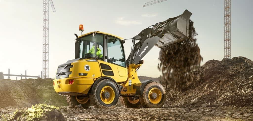 electric construction loader dumping dirt