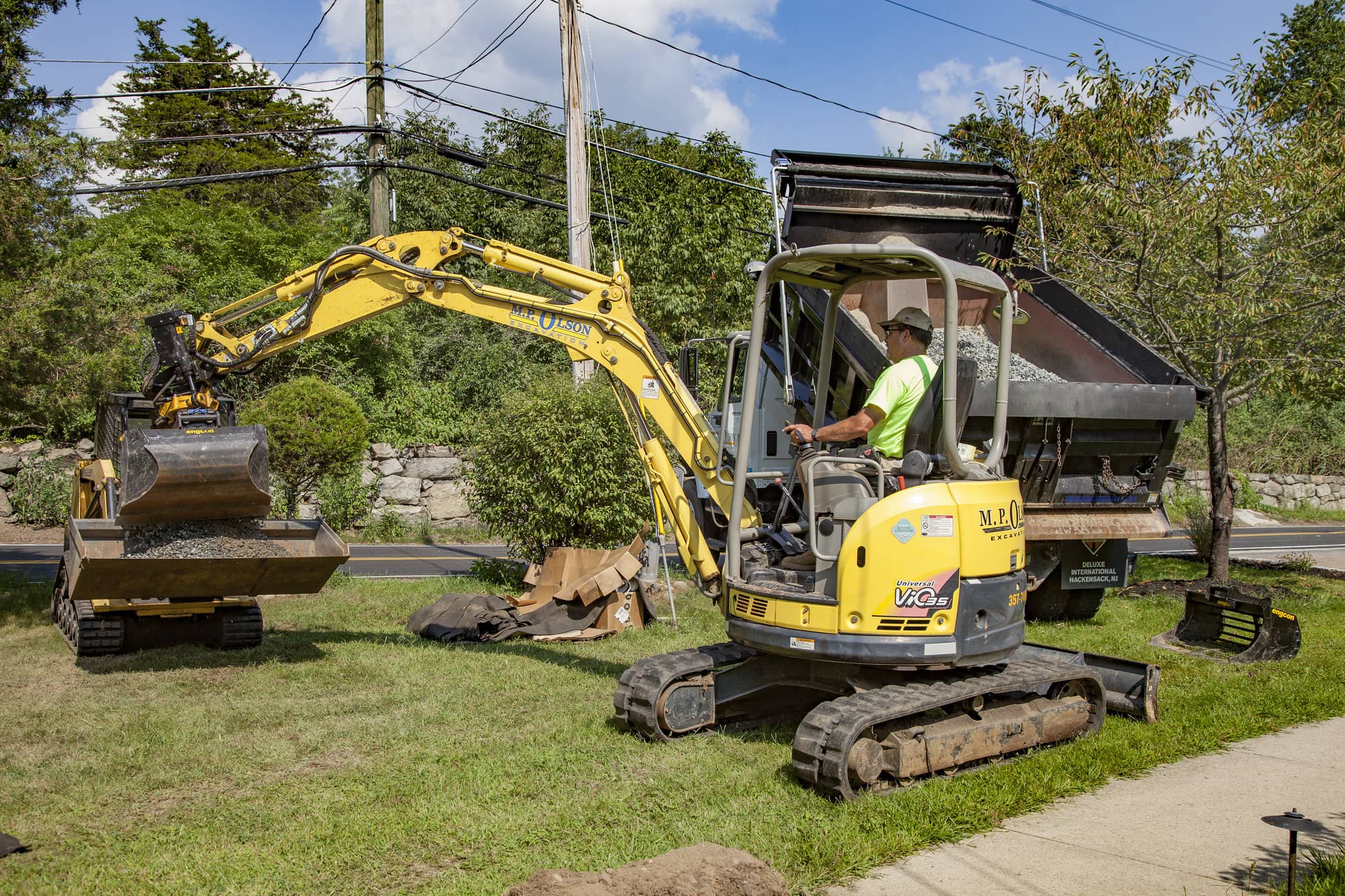 Mini excavator doing lawn work