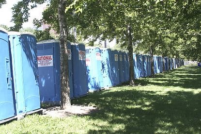 Porta Potties under trees in the shade