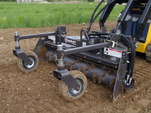 Skid steer with harley rake attachment