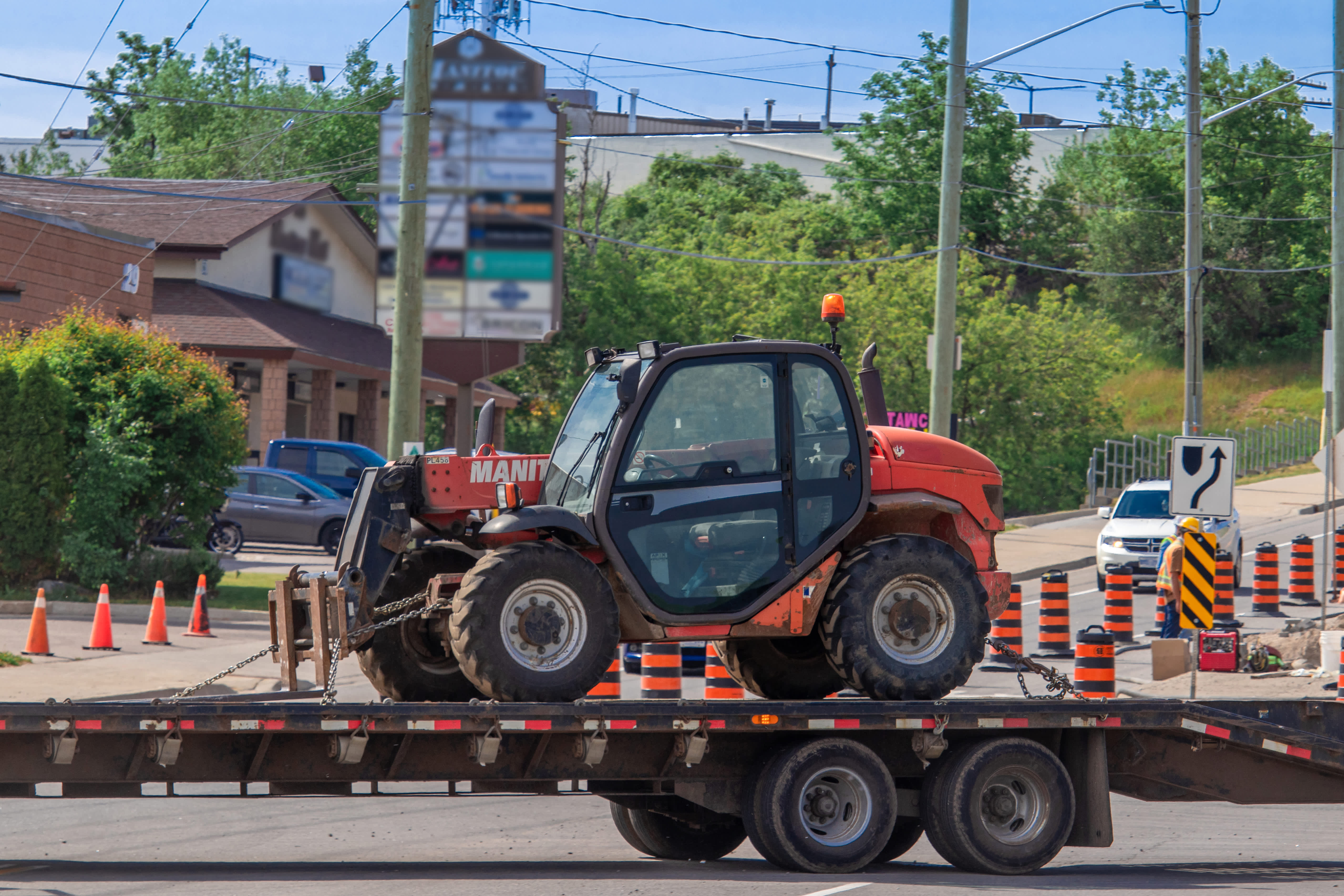 telehandler rental being delivered on flat bed