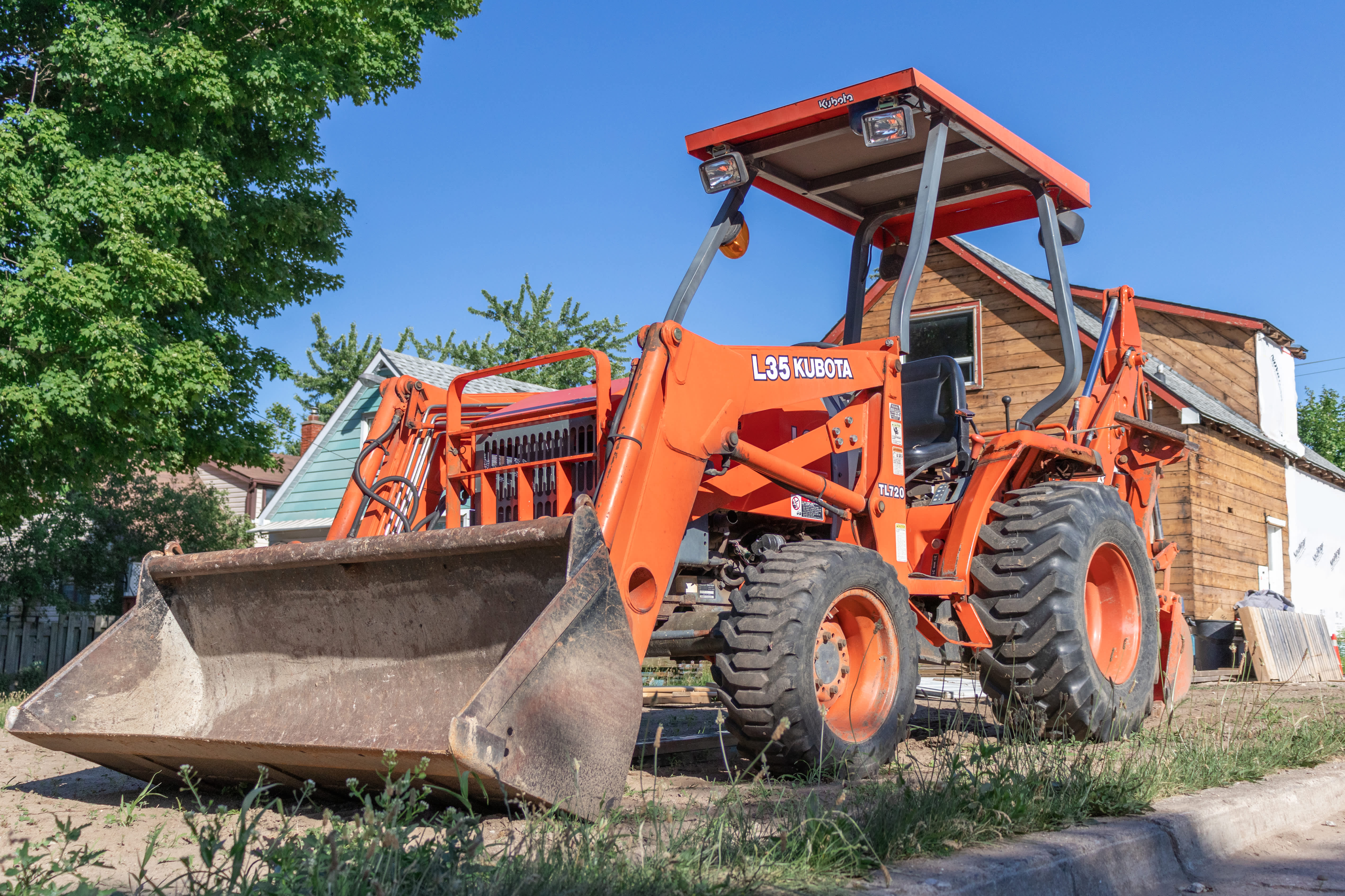 backhoe rental parked by construction site