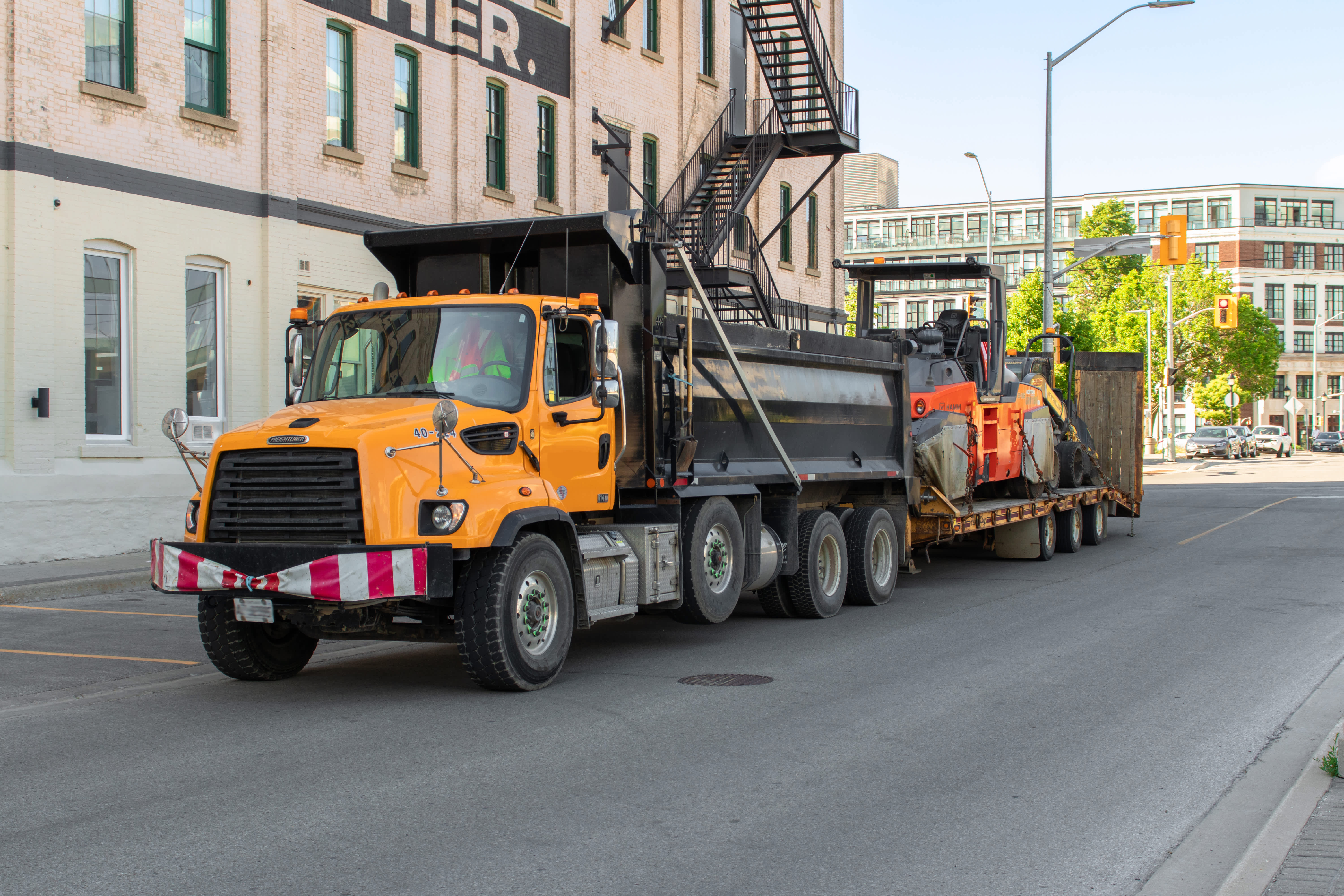 heavy equipment rental being delivered by large truck