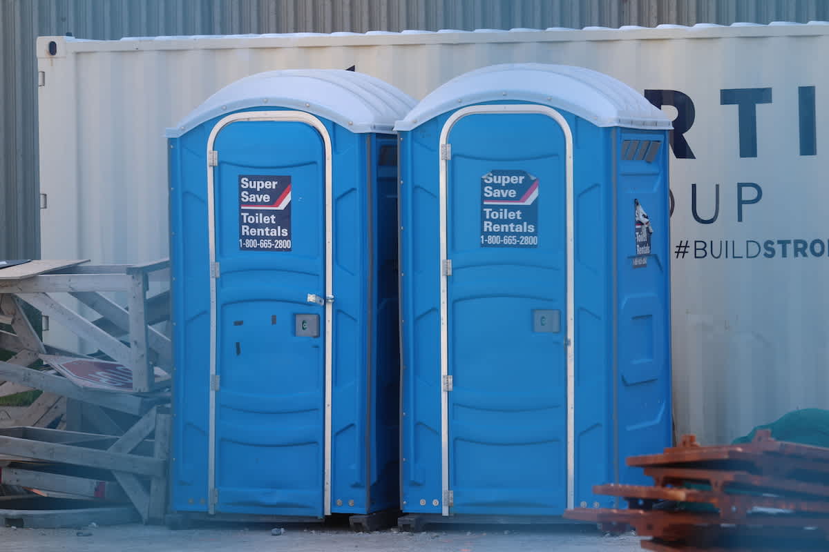 two rented porta potties on a construcion site