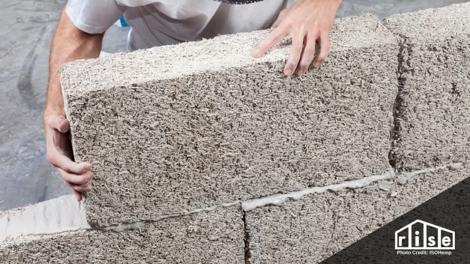 man building with hempcrete blocks