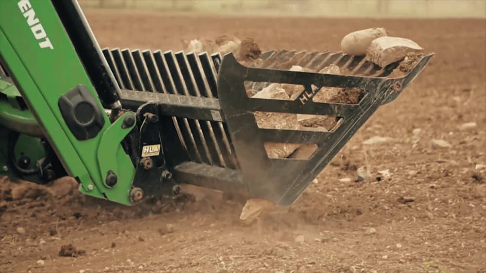 rock bucket shifting through large rocks