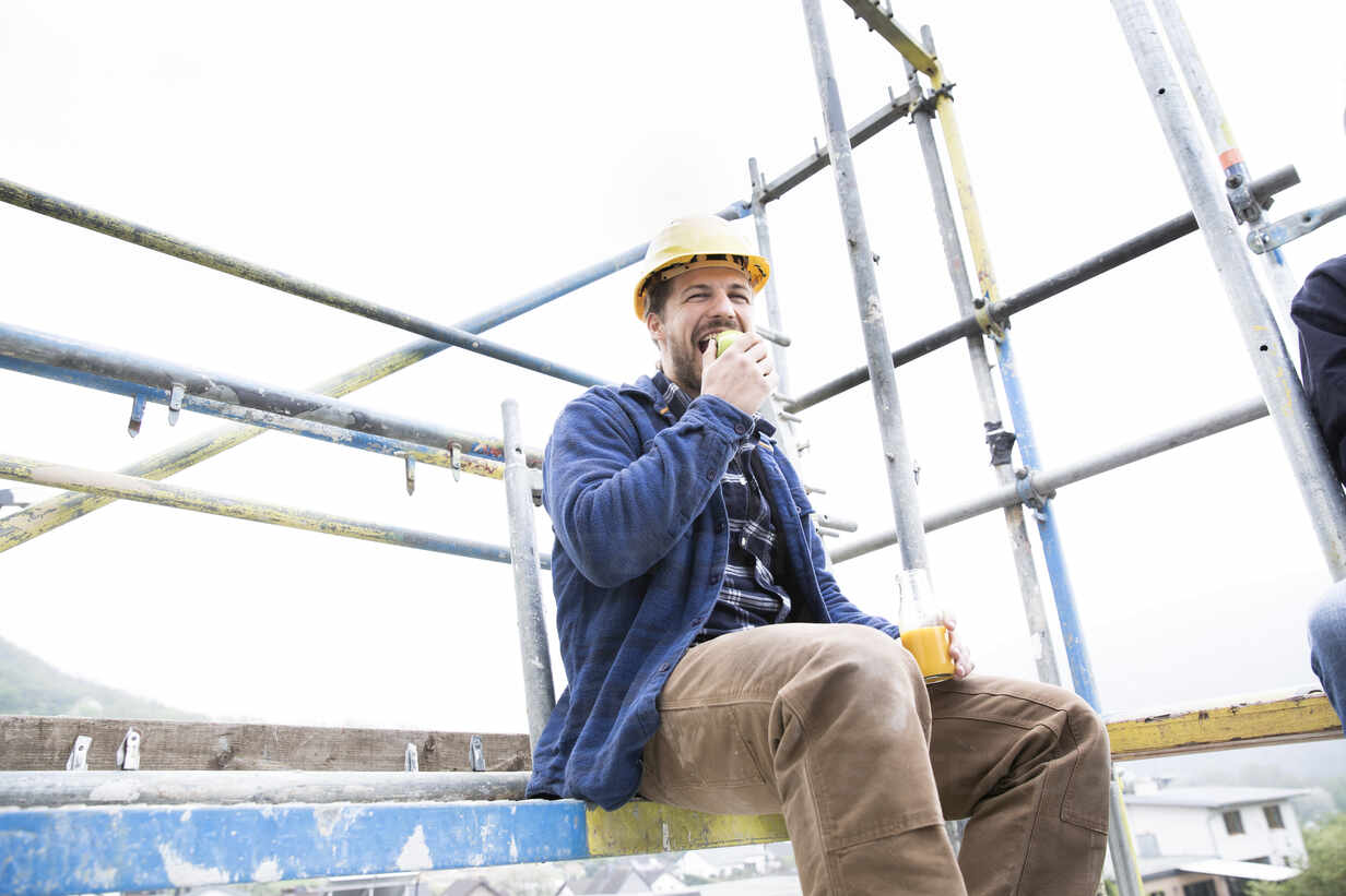 construction worker eating healthy food on construction site