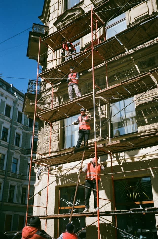 scaffolding on a construction site with construction workers on it