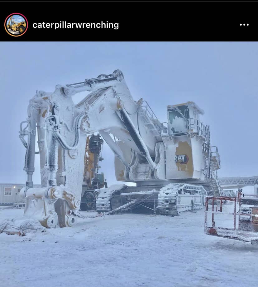 excavator covered in frost and ice in winter