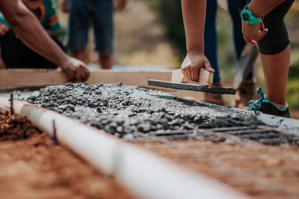 construction workers building shallow foundation wall