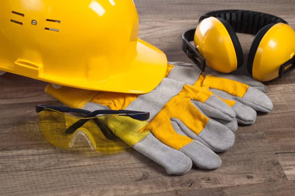 A hard hat, safety glasses, gloves and construction headphones.