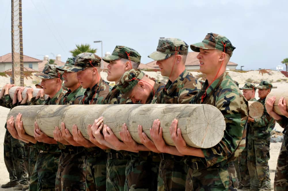 Navy Seals doing leadership training holding a log