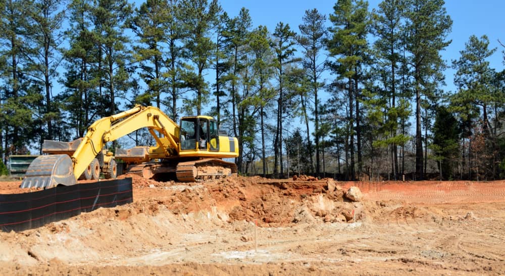 Excavator working on construction site in Alberta