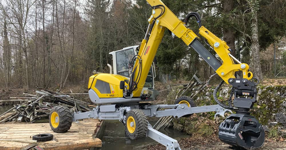 Menzi Muck spider excavator digging over river bank