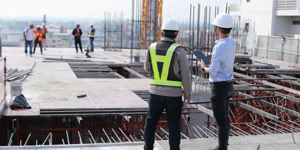 Two contractors looking over a large-scale construction project