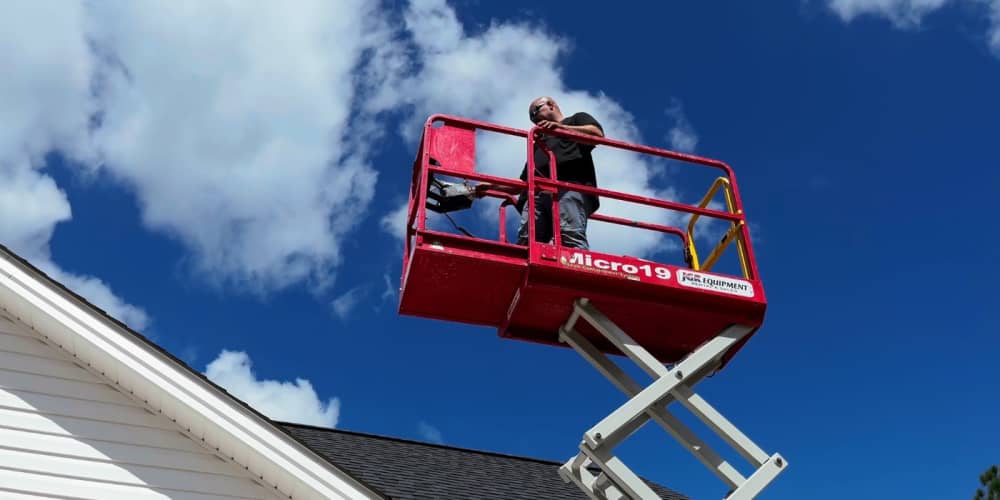 Man on a scissor lift teaching you how to operate it