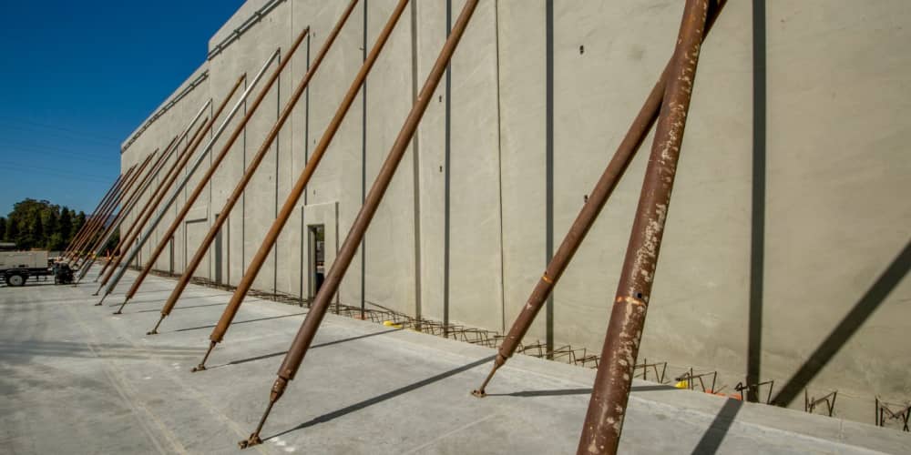 Concrete walls being hell up by temporary supports in tilt-up construction