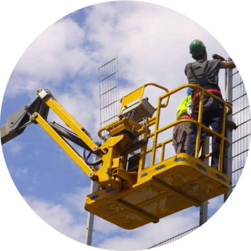 Two construction workers working on a rented boom lift in california