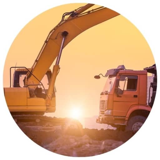 Rock truck and excavator on a jobsite in Tennessee during sunset