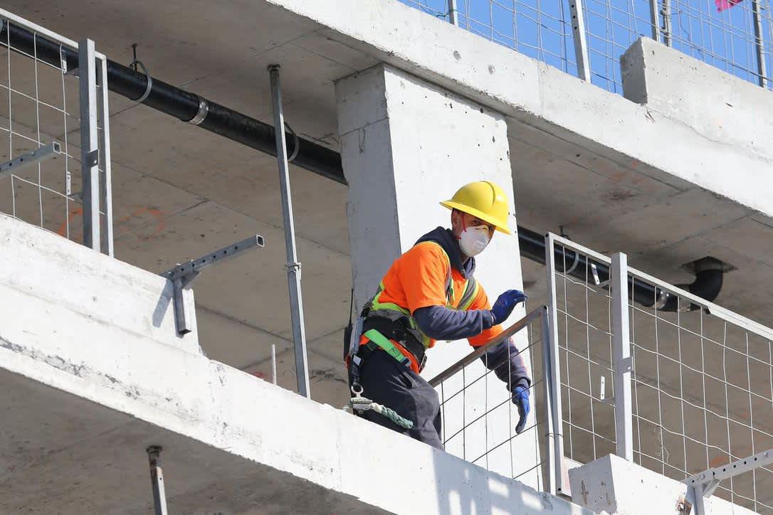 Construction worker working with face mask on