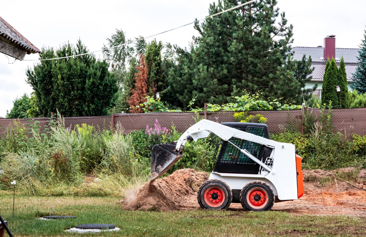 skid steer landscaping a back yard