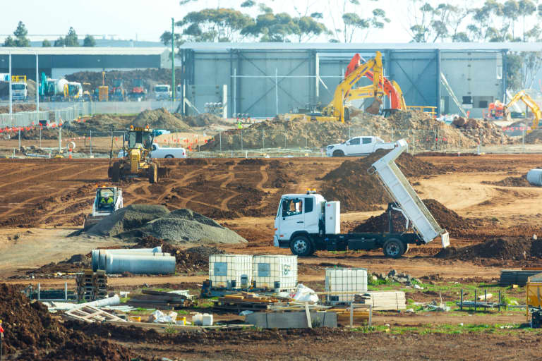 Construction workers in the rising sun