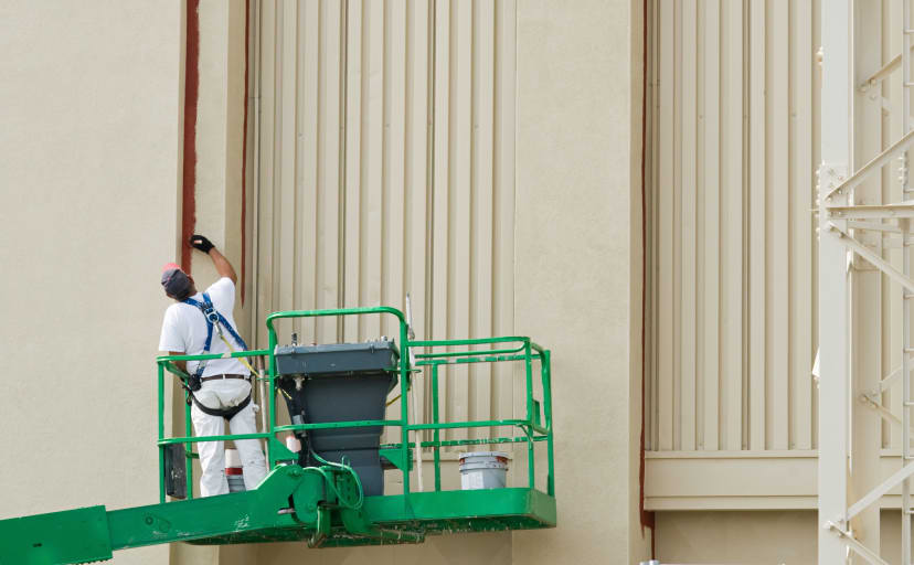 Painter using a boom lift to get the job done