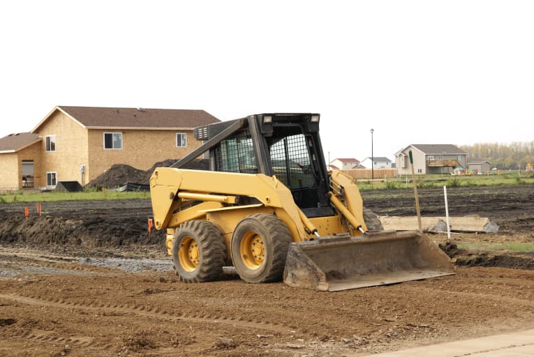 Skid steer with a bucket attachment