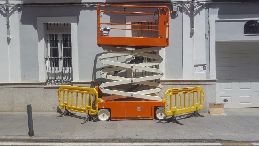 Scissor lift being used to repair windows