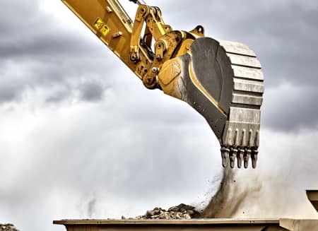 Excavator pouring dirt