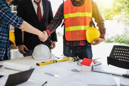 Construction worker architect and engineering shaking hands