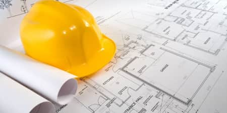 Blueprints with construction helmet