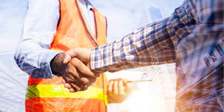 Construction workers shaking hands