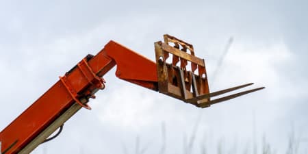 Telehandler boom and fork elevated to maximum reach