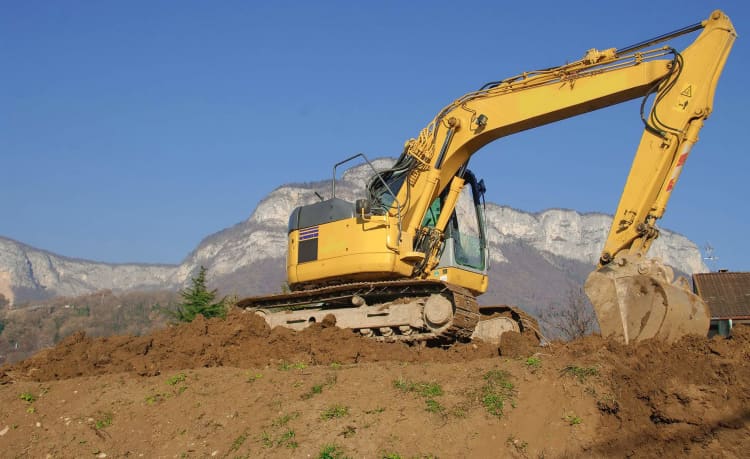 excavator on a slope hill