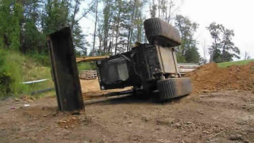 A skid steer rolled over on its side