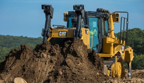 Caterpillar dozer pushing dirt