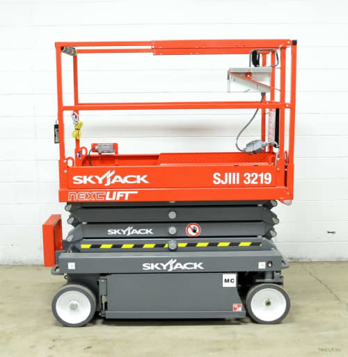 a skyjack scissor lift parked inside