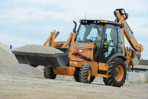 CASE backhoe driving carrying load