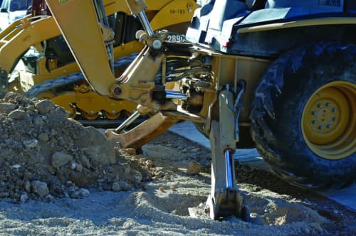 Close up of backhoe stabalizer legs