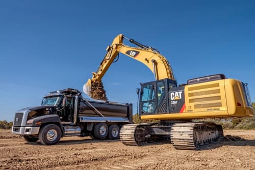 Caterpillar dumping dirt in a truck