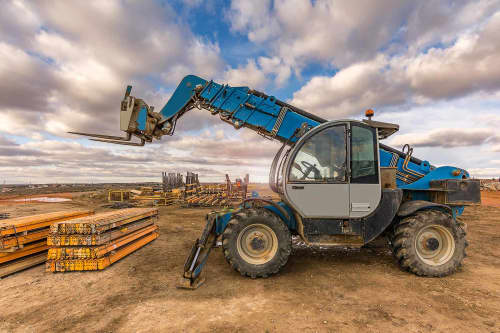 telehandler moving pallet with fork attachment